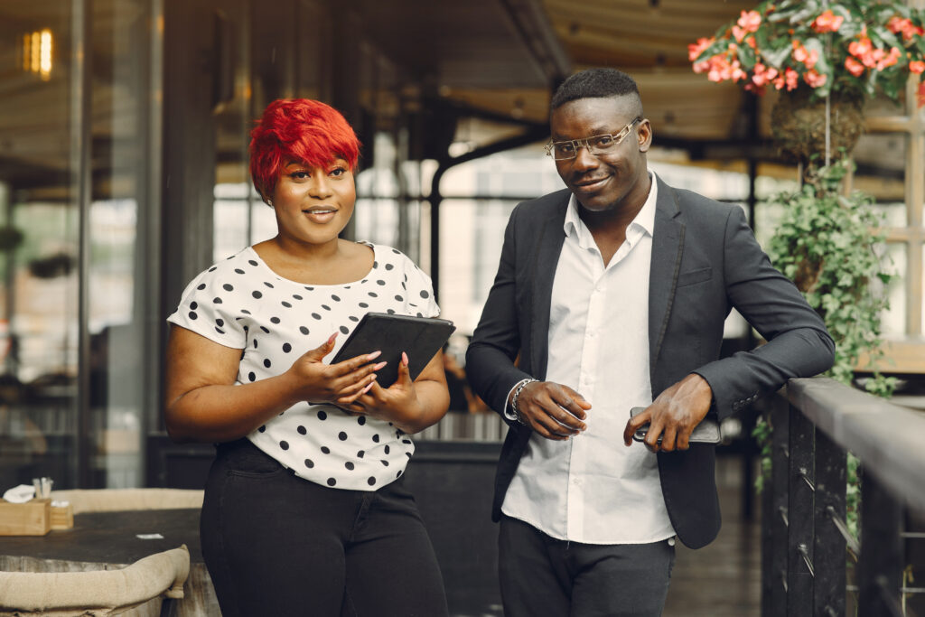 african american couple standing in a cafe with a tablet