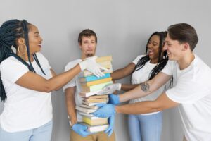 man holding bunch books donate them