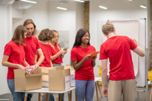 young people in red looking busy while working with donations distributing